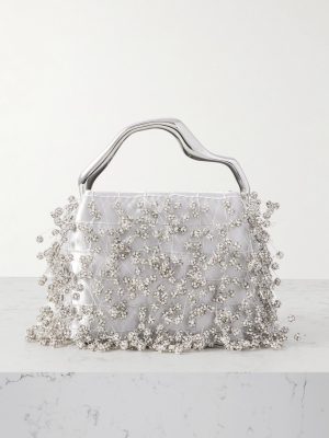 Silver clutch handbag with a sculpted metallic handle and crystal-embellished beading across white satin fabric.
