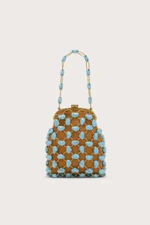 Beige background with a brown beaded handbag covered in turquoise stones and a matching turquoise bead handle chain.