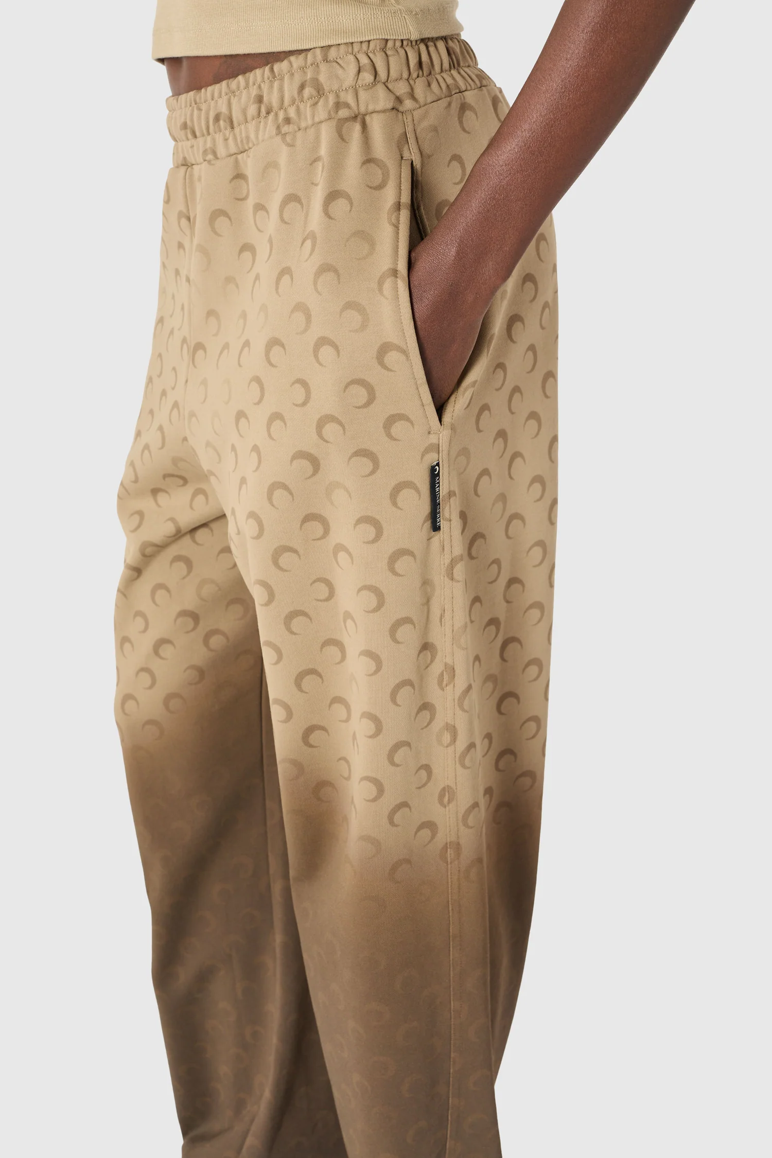 IMG_1639 - New Trend Beige jogger pants with an elastic waistband and a crescent pattern, showing a side pocket.