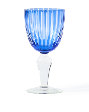 Blue ribbed glass goblet with a clear stem on a white background, photographed front-facing.