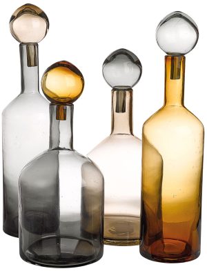Four translucent glass bottles with spherical stoppers in gray, clear, and amber hues, shown in a close-up group.