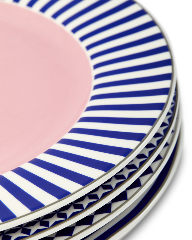 Stack of decorative ceramic plates with blue and white stripes and pink center.