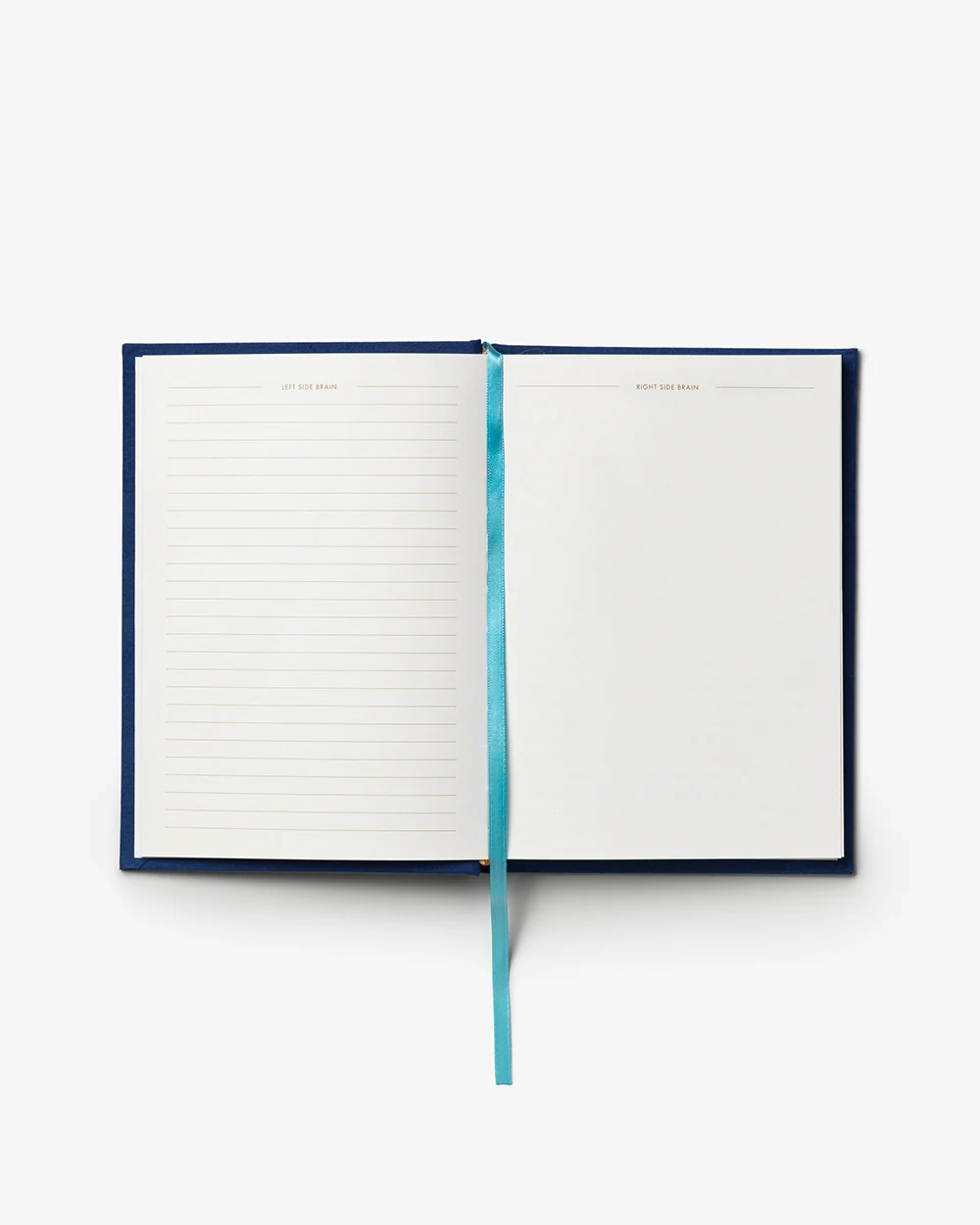 IMG_2409 - New Trend Open navy notebook with a turquoise ribbon bookmark; left page lined, right page blank.