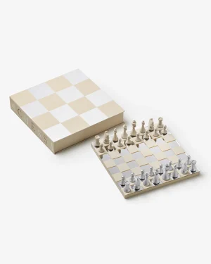 Cream and white chess set with a checkered board and matching box beside it