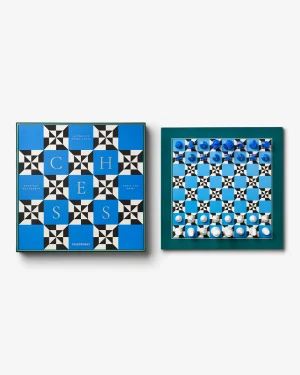 Two framed chess-themed artworks in blue tones: the left board shows the word CHESS in large letters on a geometric pattern, the right board displays a blue and white checked grid with pieces.