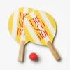 Two yellow and white striped pickleball-style paddles with wooden handles and a small red ball on a white background, ready for a paddle ball game