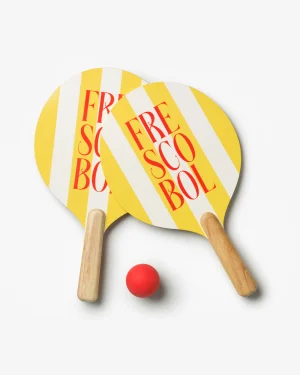 Two yellow and white striped pickleball-style paddles with wooden handles and a small red ball on a white background, ready for a paddle ball game