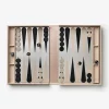 Open backgammon board in a blush pink case with black and beige points, checkers positioned on both sides and two dice visible.