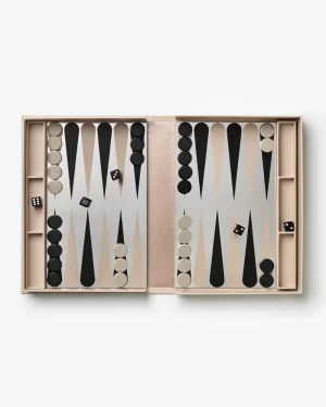 Open backgammon board in a blush pink case with black and beige points, checkers positioned on both sides and two dice visible.