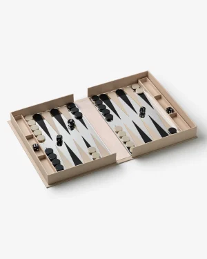 Open backgammon set on a light surface, two sides with beige and black checkers and dice, showing a game in progress on the board.
