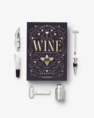 Dark blue hardcover book titled 'WINE' with gold ornate design, surrounded by wine tools (corkscrew, foil cutter, stopper, pour spout, thermometer) on a white background