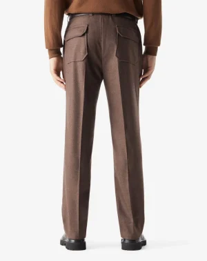 Back view of brown tailored trousers with flap pockets and a belt, paired with a brown top.