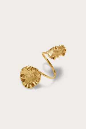 Gold ring featuring a large textured leaf motif against a pale beige background.