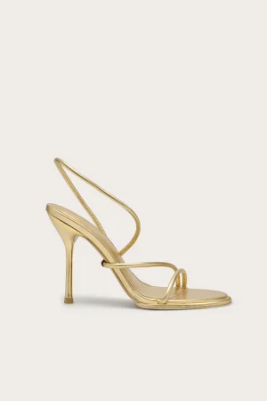 Gold metallic strappy high-heeled sandal, side view, with slender stiletto heel and minimalist straps