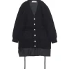 Black textured cardigan with white-button front over a dark pinstriped shirt peeking from the bottom, layered look
