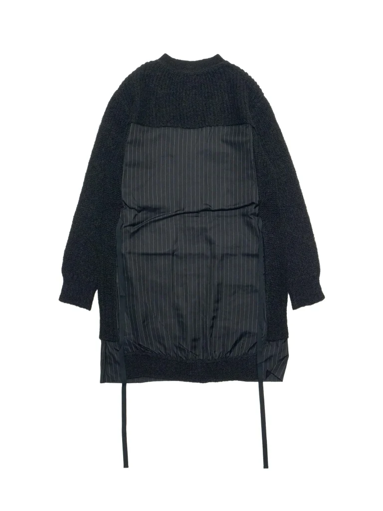 Back view of a black textured knit coat with a padded pinstripe panel down the back