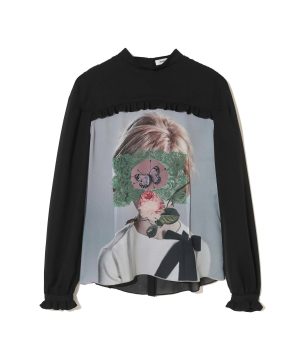 Black long-sleeve top with a large graphic print of a person’s portrait overlaid by green lace and flowers on the chest area