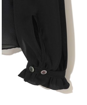 Close-up of a black garment sleeve with a gathered cuff and two buttons, showing a ruffled edge.