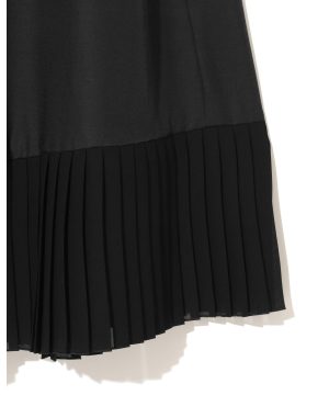 Black fabric with a pleated hem, likely a pleated skirt or dress edge.