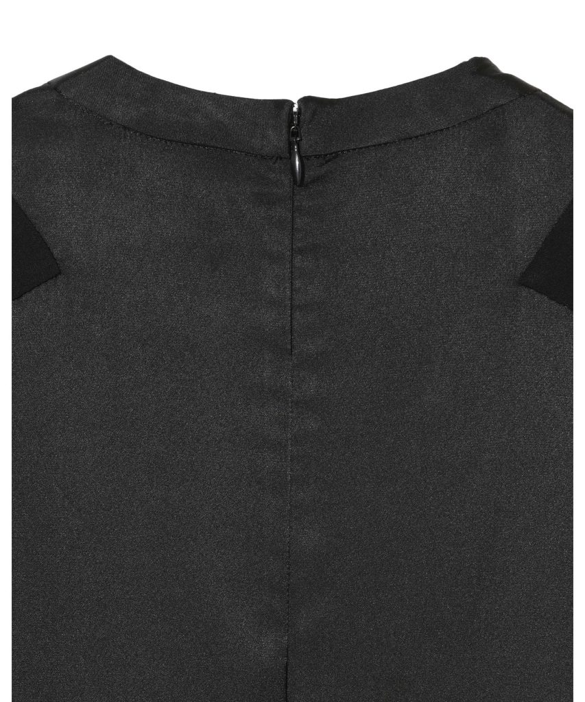 Close-up of black fabric showing a centered back zipper at the neckline of a garment.