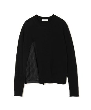 Black knit sweater with a hidden striped lining on the left side and a white brand tag (Undercover) at the neckline edge.