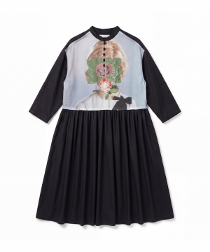 Black dress with a pale blue bodice featuring a portrait print overlaid by green lace, and a gathered waist.