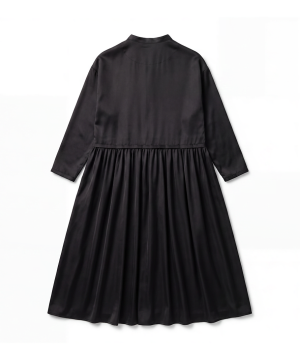 Back view of a black long-sleeve dress with a gathered waist and flowing, full skirt.