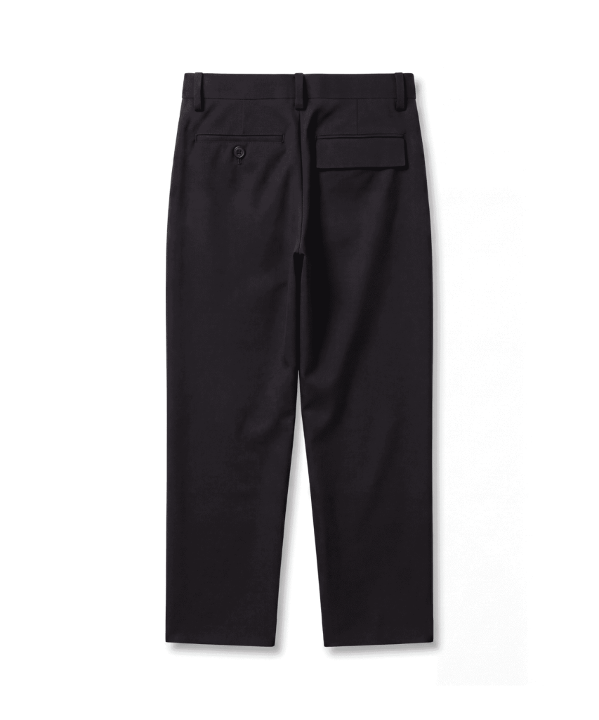 Back view of black dress pants showing a small buttoned welt pocket on the left and a rectangular flap pocket on the right