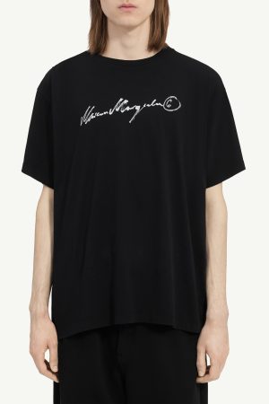 Black oversized t-shirt with a white handwritten logo across the chest center (cropped at shoulders).