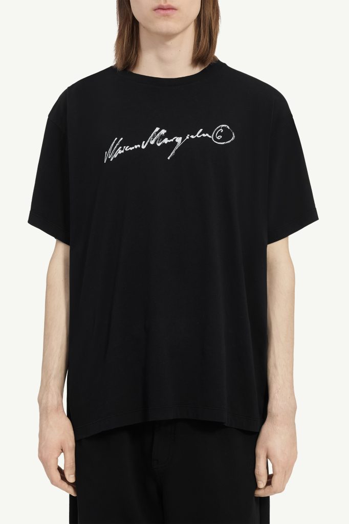Black oversized t-shirt with a white handwritten logo across the chest center (cropped at shoulders).