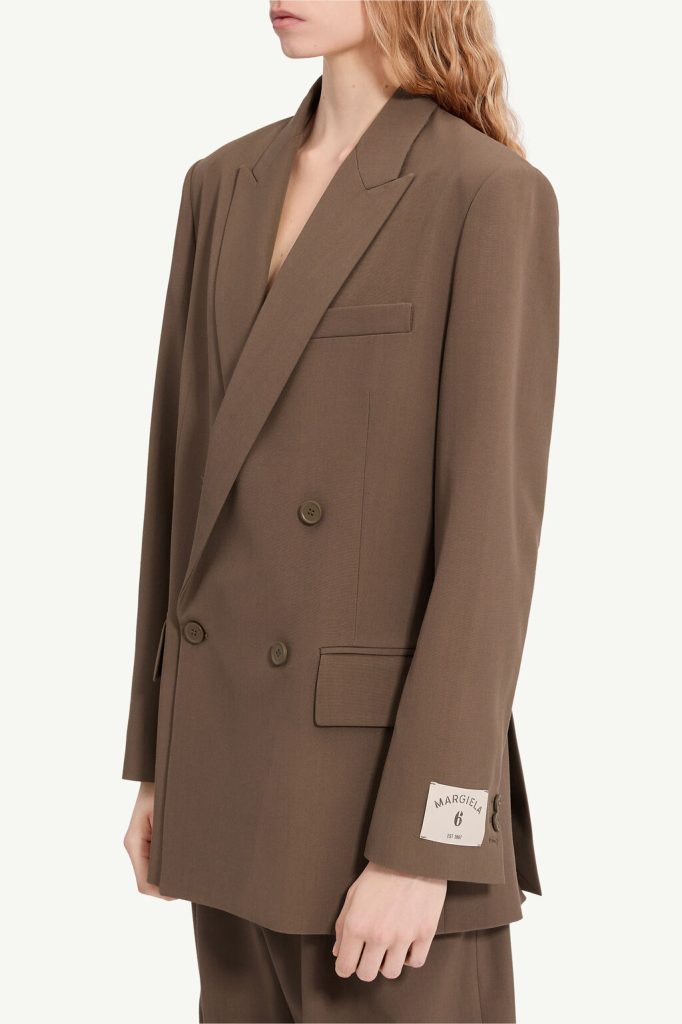 Brown oversized double-breasted blazer with wide notch lapels and two-button front, featuring a chest pocket and sleeve label detail