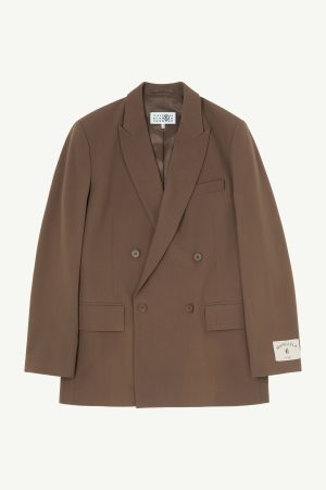 Brown double-breasted blazer with peaked lapels, four buttons, and two front flap pockets on a light background.