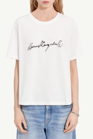 White short-sleeve crew-neck T-shirt with a black cursive logo across the chest and a circled 6 on the right side.