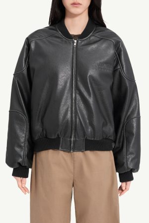 Person wearing a black leather bomber jacket with a front zipper and ribbed cuffs and hem.