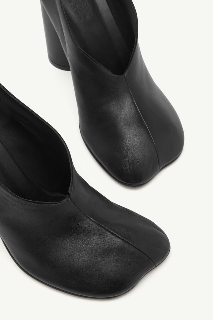 Pair of black leather ankle boots with rounded toes and chunky heels, photographed from above.
