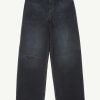 Pair of dark denim jeans with a ripped knee on the left leg, showing orange stitching and frayed hem on top edge.