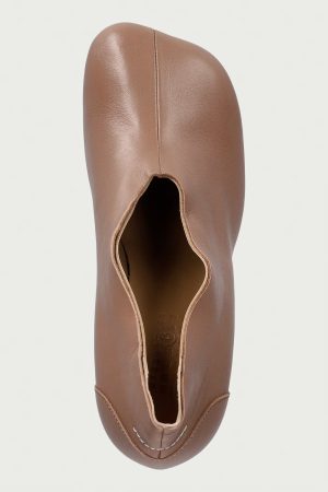 Top-down view of a brown leather loafer with a rounded toe and visible stitching along the front edge.