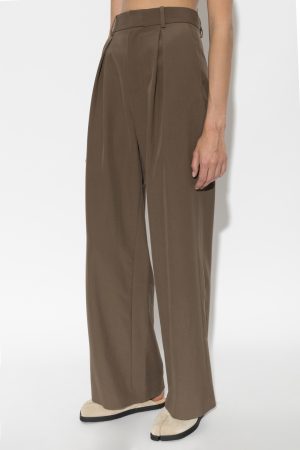 Brown high-waisted, wide-leg trousers with front pleats and belt loops, paired with beige loafers.