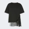 Black oversized T-shirt with long fringe tassels on the side, mid-length sleeves, casual streetwear style