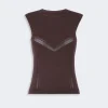 Brown sleeveless knit top with a chevron perforated stripe across the chest area for decorative detail.