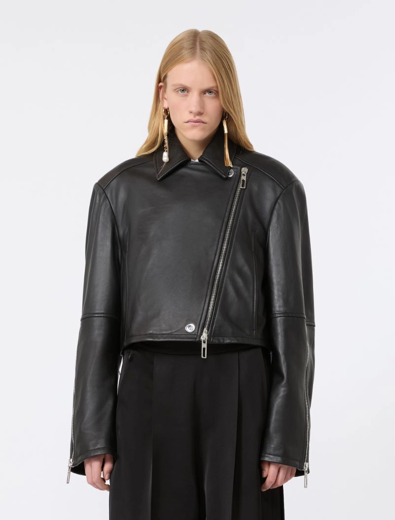 IMG_3048 - New Trend Model wearing a black leather biker jacket with an asymmetrical zipper and silver hardware, paired with black trousers and statement earrings.