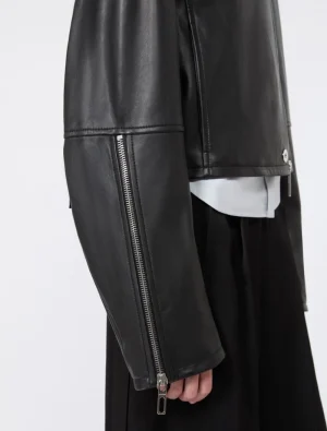 Close-up of a black leather jacket sleeve with a metallic zipper