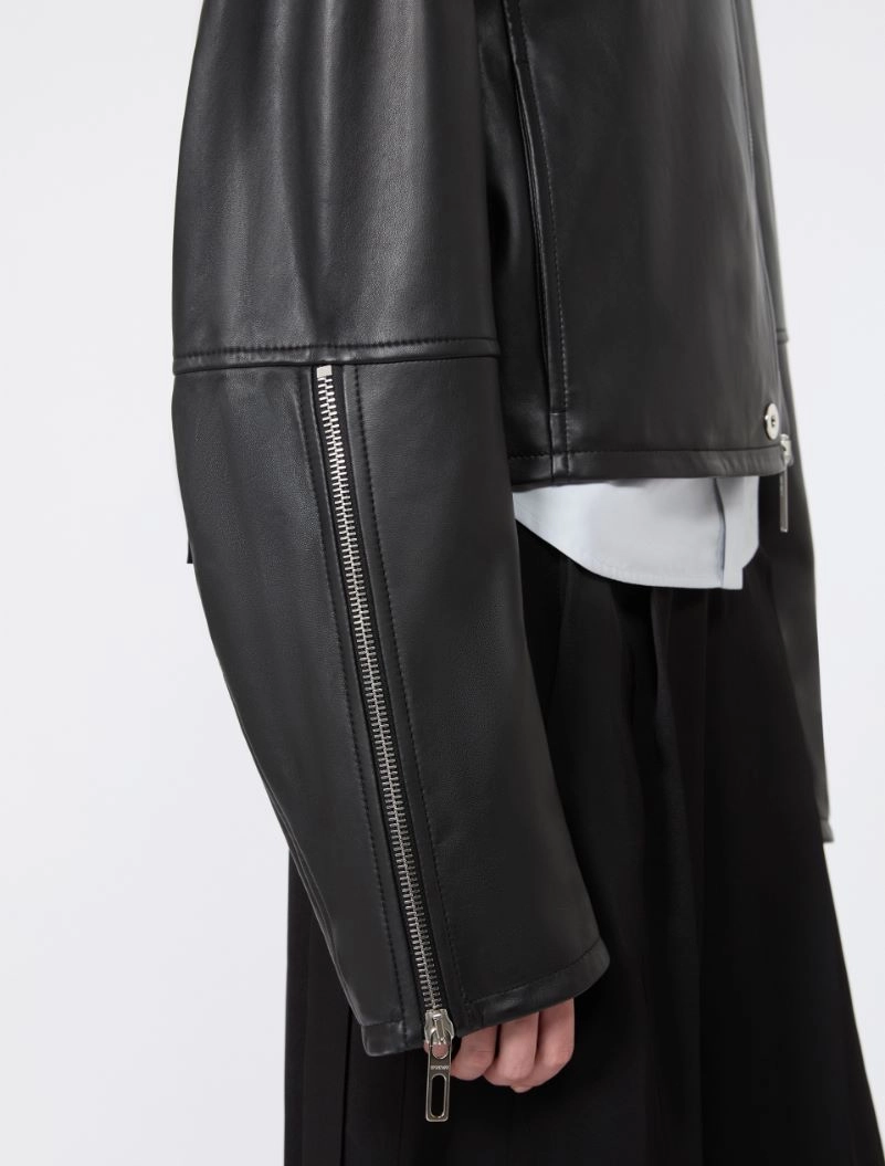 IMG_3051 - New Trend Close-up of a black leather jacket sleeve with a metallic zipper