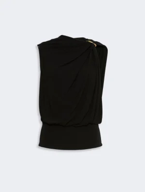 Black draped one-shoulder top with a gold shoulder clasp and ruched detailing, viewed from the back branch of the garment in a studio setting.