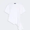 White oversized short-sleeve T-shirt with an asymmetric draped hem and ruffled lower edge on one side.