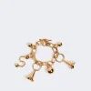 IMG_3112 - New Trend Gold charm bracelet with multiple dangling charms on a pale background, jewelry accessory image for product listing