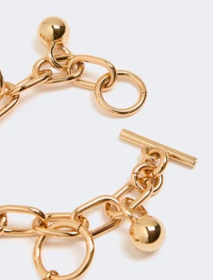 Gold-tone chain bracelet with chunky interlocking links and a toggle clasp, close-up view.