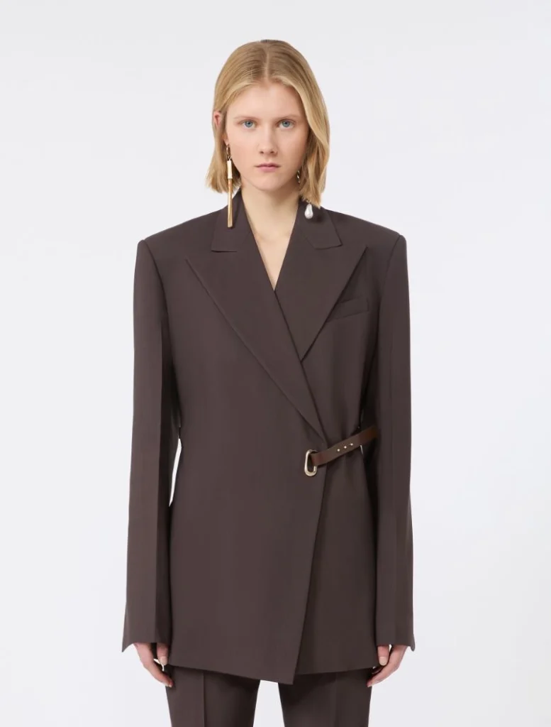 Brown wrap-style blazer with a matching belt and gold buckle on a female model.