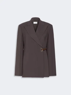 Brown belted, wrap-style blazer with wide lapels and a neutral background for a tailored look.