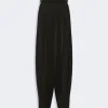 Black high-waisted, wide-leg tailored trousers with front pleats.